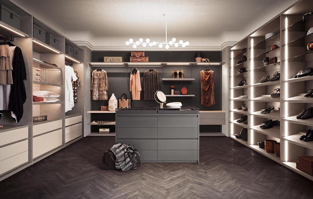 Walk in dressing rooms with open plan storage and an island storage in the middle by IN Design Kitchens and Living Spaces | Kent and Sussex