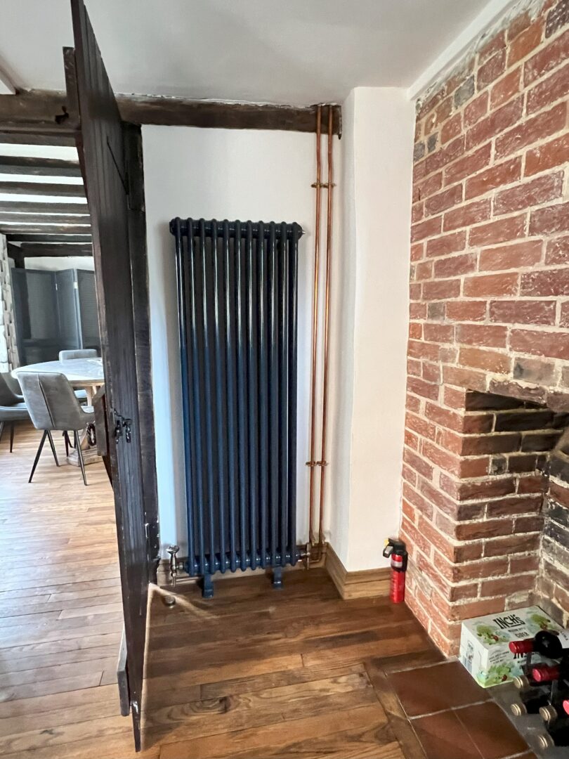 Blue painted radiator with vintage valves