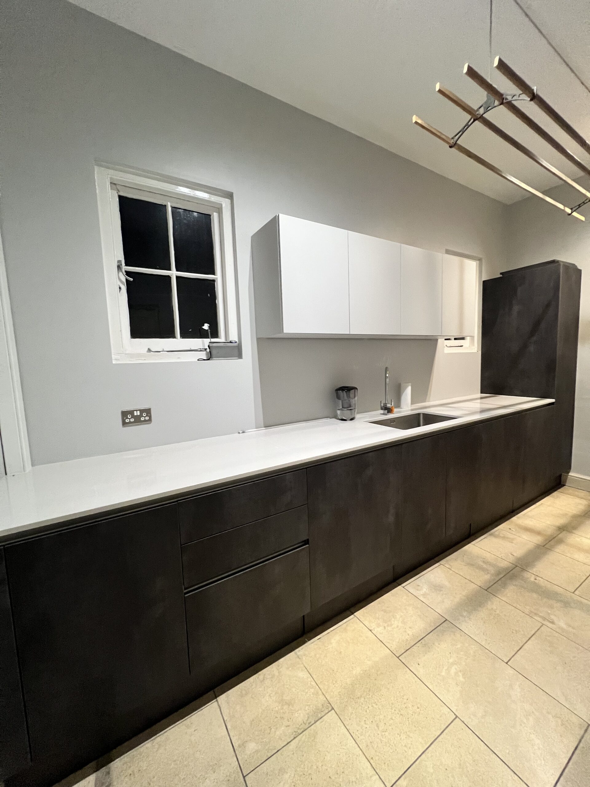 Utility room with Quartz worktops and undermounted sink and units . German Kitchens